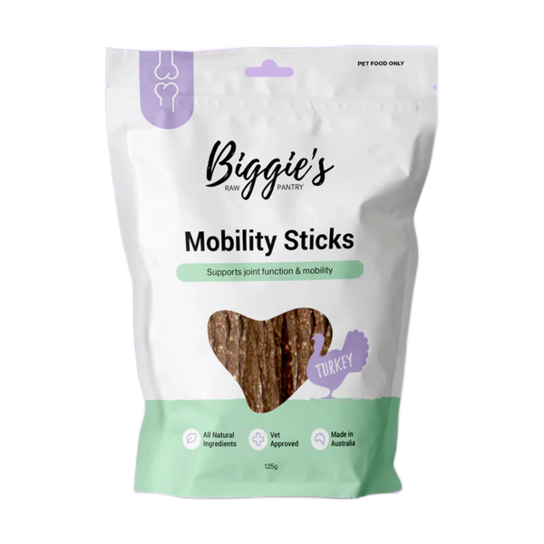 A package of Biggies Mobility Sticks, featuring a heart-shaped window showing the product inside. The bag is primarily white with mint green accents and includes text emphasizing support for joint function and mobility, along with.