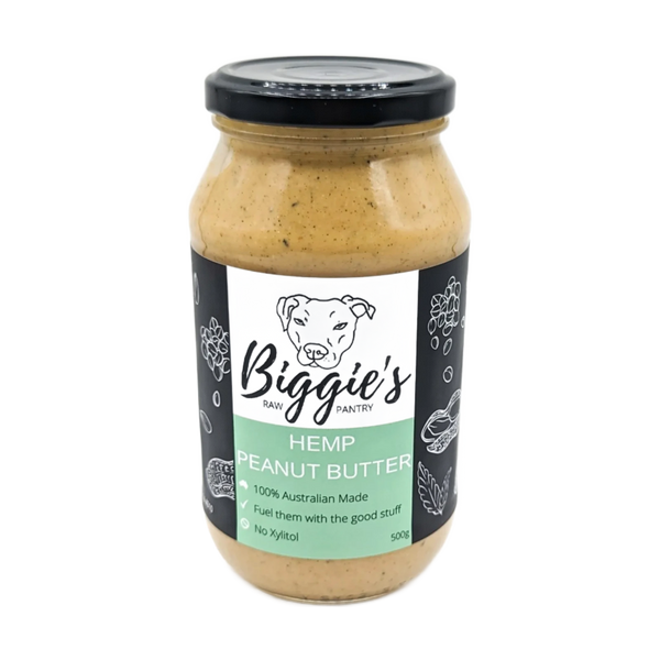 A jar of Biggies Hemp Peanut Butter, labeled clearly with Hemp Peanut Butter and featuring a dog illustration. The jar is filled with a creamy, light brown spread, showcasing a natural and wholesome product design.