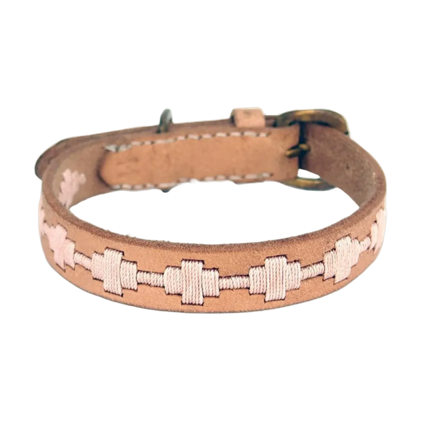 A handmade dog collar featuring a natural leather band, adorned with a decorative pattern of cream-colored stitching. The collar has a buckle closure and showcases a soft, laid-back design, perfect for an indie style.